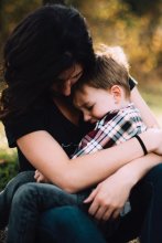 Photo credit: Jordan Whitt. Photo of mom holding toddler on her lap