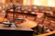 A scale on a table in a courtroom