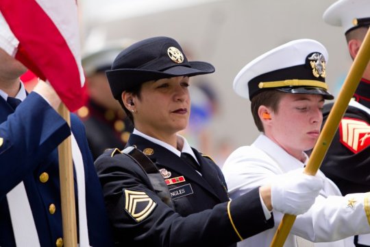 Woman in uniform holding flag